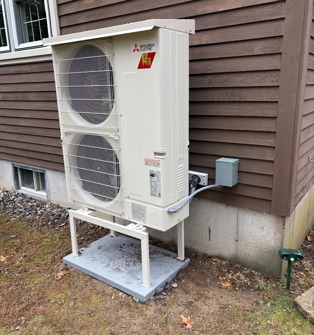 Mitsubishi cold-climate heat pump outdoor unit installed at a Maine home