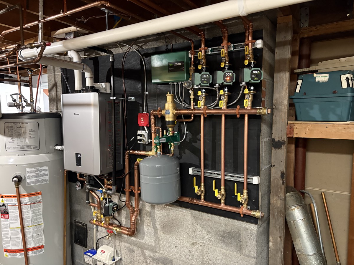 Modern wall-hung condensing boiler installed in a Maine home utility room