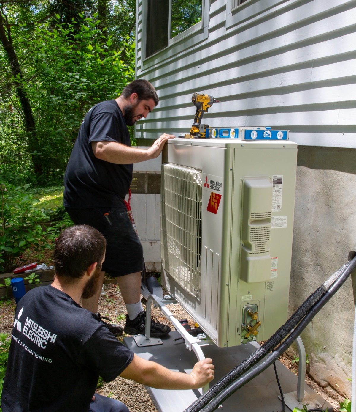 Side by side comparison of a cold-climate heat pump and wall-hung condensing boiler in Maine home